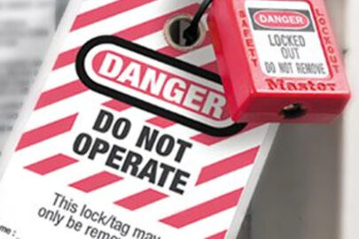 Lockout tagout safety lock and tag on machinery indicating maintenance in progress